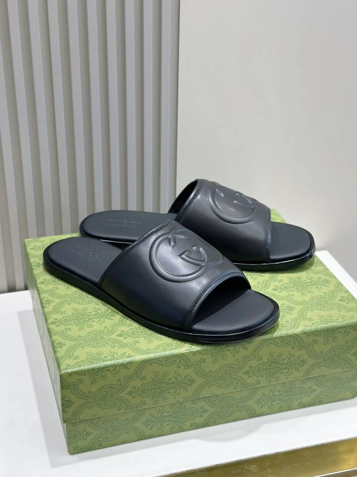 GUCCI || Black Leather GG Embossed Slides – Iconic Luxury Footwear- FASHION MYST
