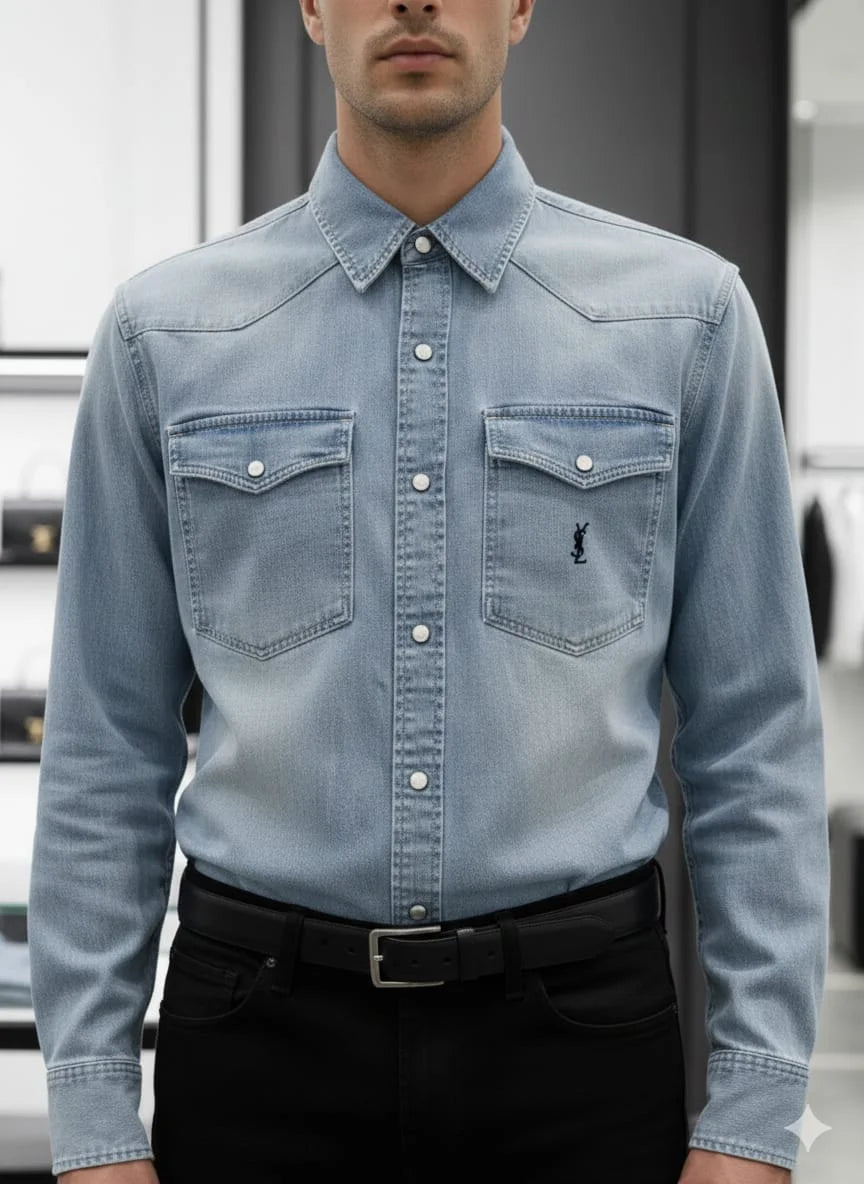 Model wearing Saint Laurent YSL blue denim western shirt with monogram pocket in luxury boutique