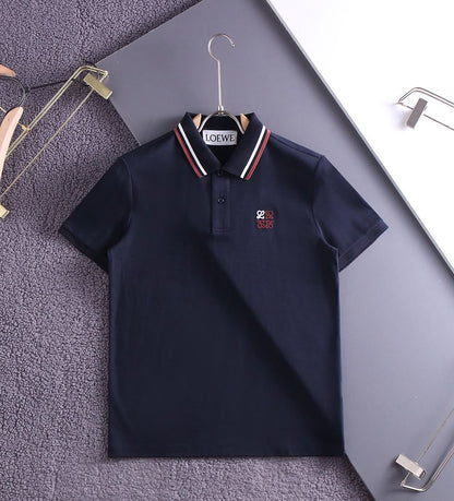 Navy premium polo shirt with striped collar on hanger, flat view
